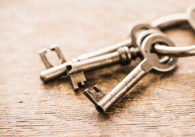 Close-up of a group of antique skeleton keys on wooden background